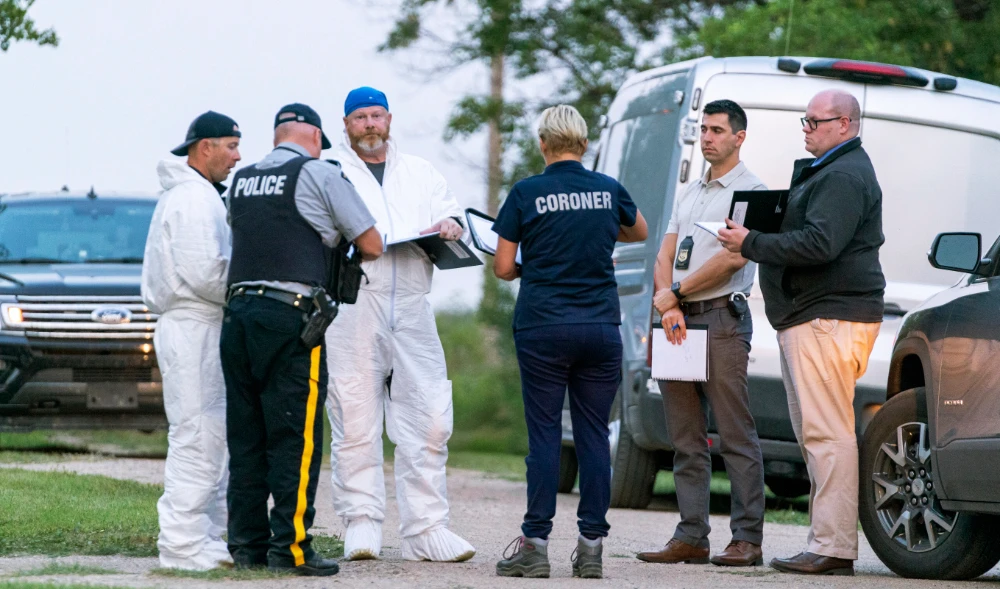 Investigators gather in front of the scene of a stabbing in Weldon, Saskatchewan, Sunday, Sept. 4, 2022. (AP)