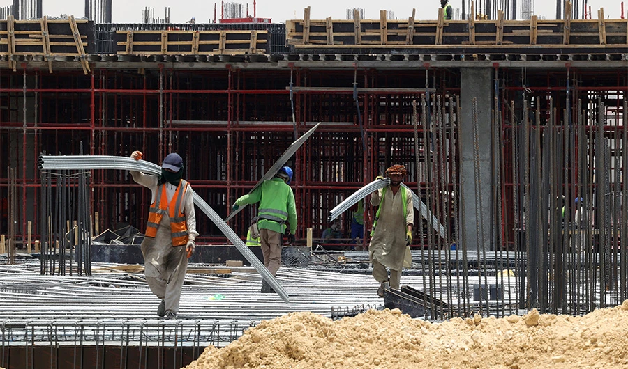 Foreign labourers work at a construction site in the Saudi capital Riyadh, on June 16, 2022. (AFP)