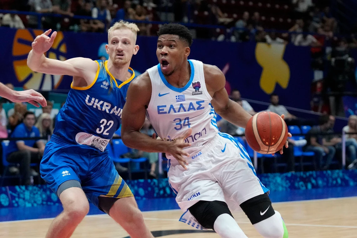 Greece's Giannis Antetokounmpo, right, drives around Ukraine's Bogdan Bliznyuk during their EuroBasket Group C match in Milan Tuesday. (AP)