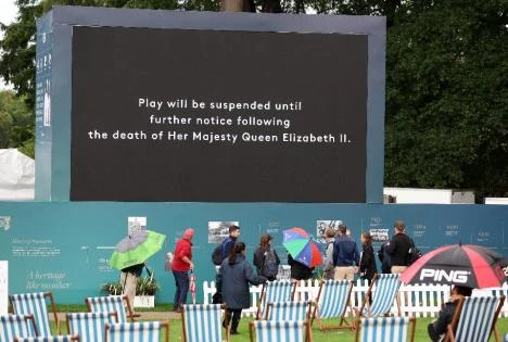 General view as the big screen displays a message after the death of Britain's Queen Elizabeth as play is suspended at the BMW PGA Championship Thursday. (Reuters)
