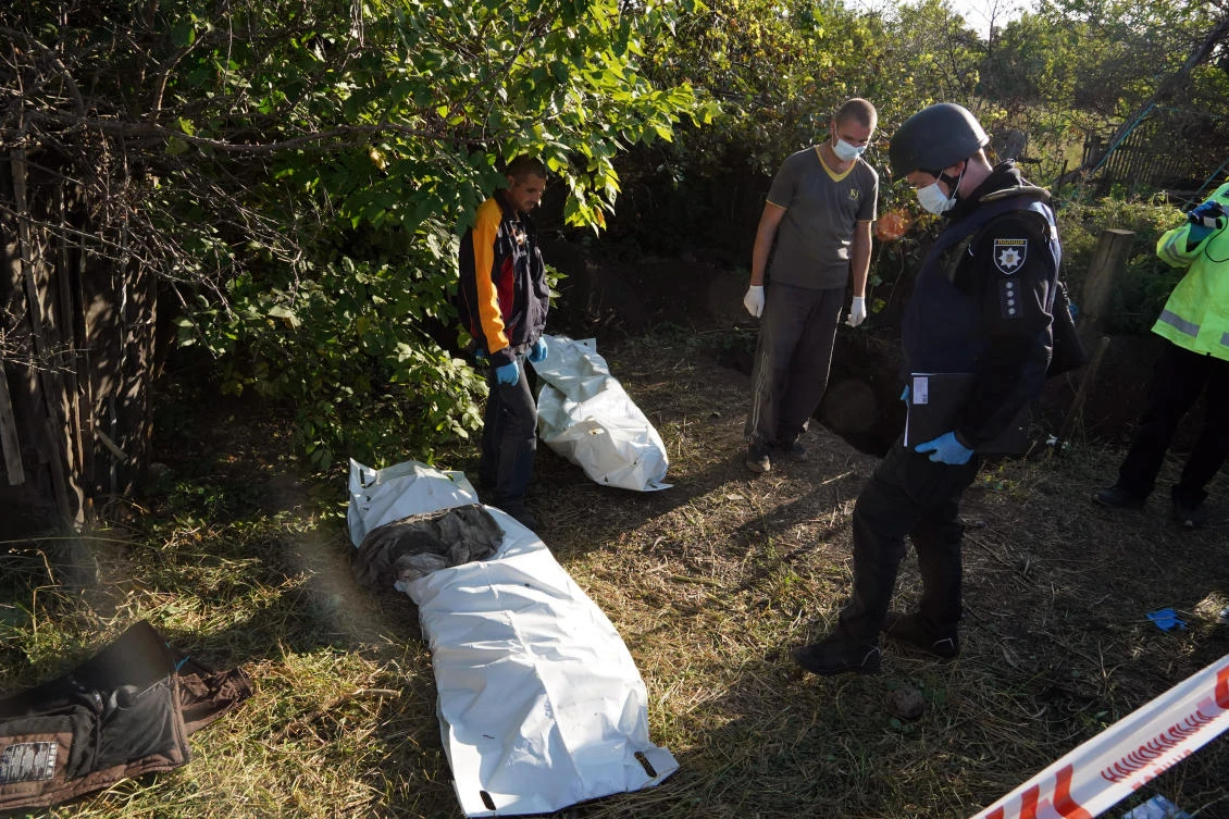 Ukrainian police exhume unidentified bodies of people killed by the Russian troops in the village of Grakove in the Kharkiv region on Sept. 9, 2022. (AP)