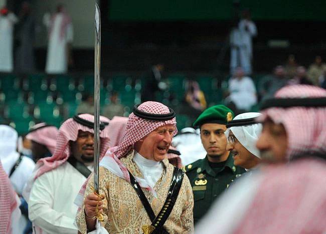 Wearing traditional Arab robes, the former Prince Charles takes part in a Saudi sword dance known as ardah at the Janadriyah cultural festival near Riyadh in February 2014. (REUTERS/File)