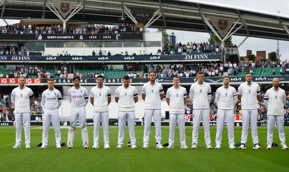 England players wearing black armbands stand during a minutes silence before the match following the passing of Britain’s Queen Elizabeth on September 10, 2022. (Reuters)