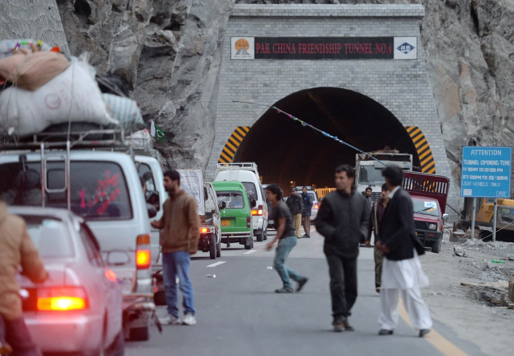Pakistani tourists and passenger vehicles wait to travel through a newly built tunnel in northern Pakistan's Gojal Valley. (AFP file photo)