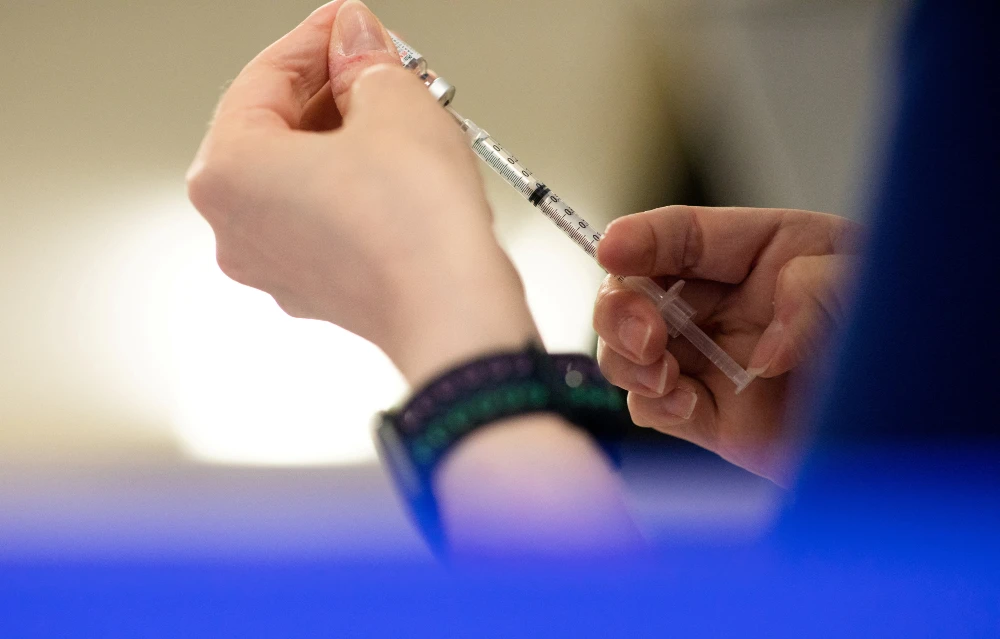 A nurse fills up syringes with the coronavirus disease (COVID-19) vaccines. (REUTERS)