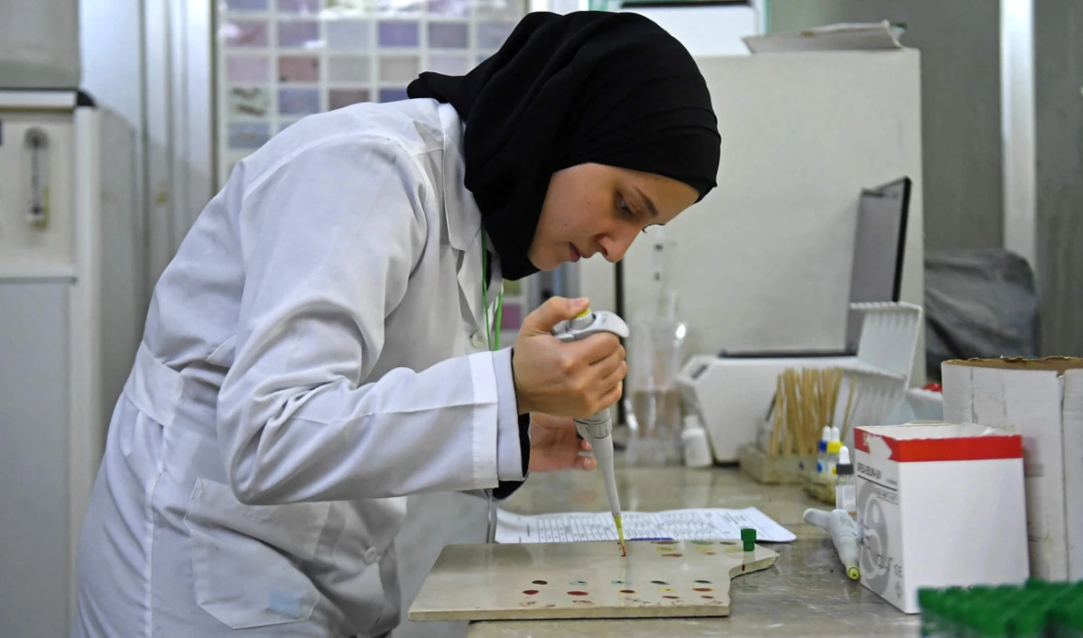 A lab technician works on samples to test for cholera in Aleppo. (AFP)