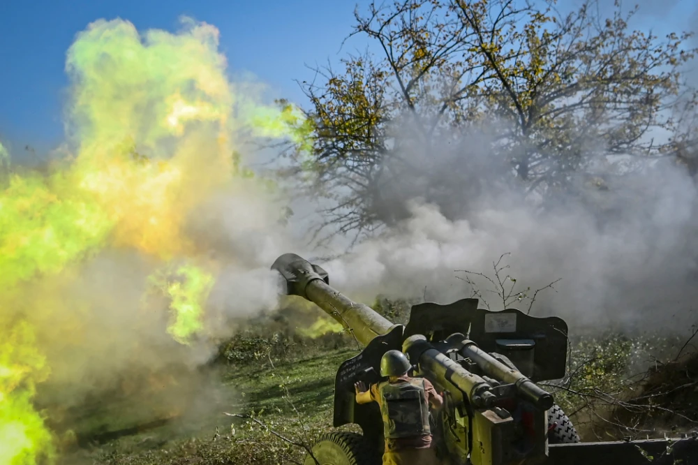 An Armenian soldier fires artillery on the front line during the ongoing fighting between Armenian and Azerbaijani forces over the breakaway region of Nagorno-Karabakh. (AFP file photo)
