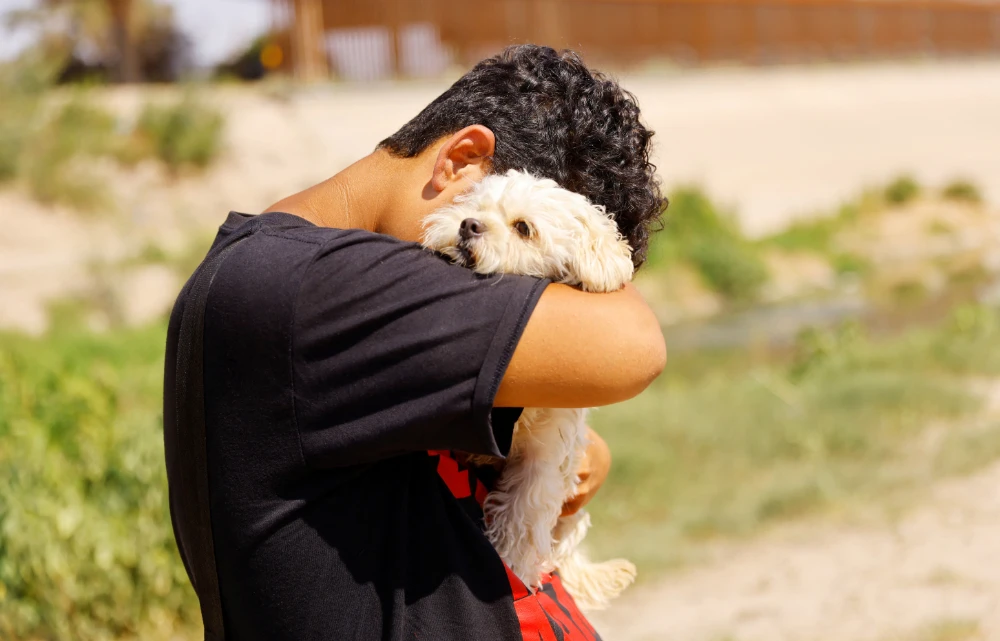 After risky journey, migrant and his dog say goodbye at US border