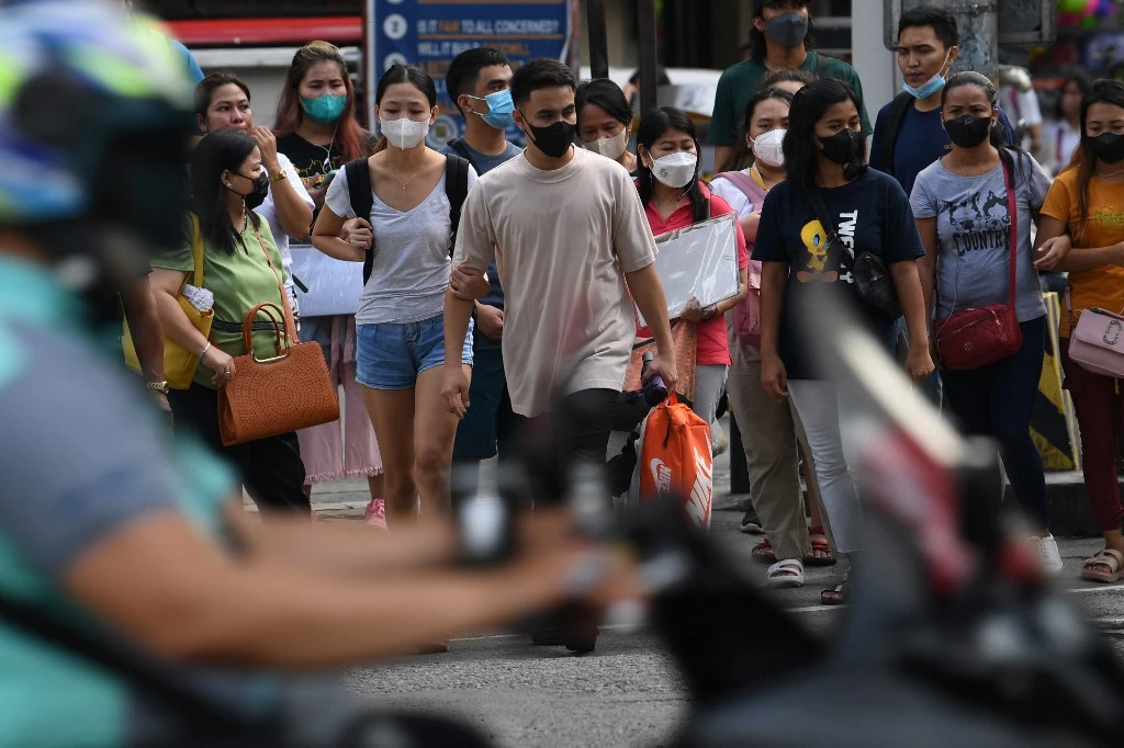The optional wearing of facemasks outdoors will be implemented in phases in coordination with local government units. (AFP)