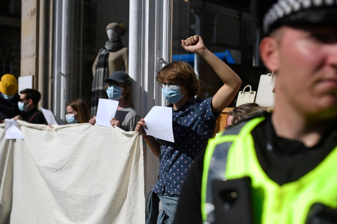 Anti-Royalist protesters hold up blank placards in a demonstration against the way their protests are being policed, in Edinburgh on Tuesday following the death of Queen Elizabeth II on Thursday. (AFP)