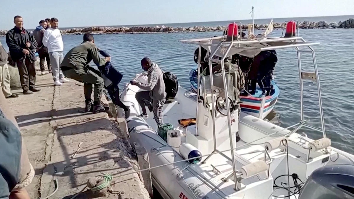 A Tunisian national coast guard helps a migrant child to get off a rescue boat in Jbeniana, Safx, Tunisia in this screen grab taken from a handout video taken April 23, 2022. (Reuters/File)