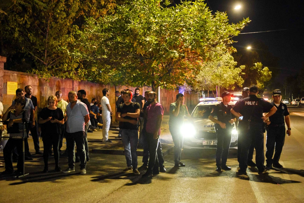 Relatives of servicemen, who were wounded in night border clashes between Armenia and Azerbaijan, gather outside a military hospital in Yerevan on September 13, 2022. (AFP)