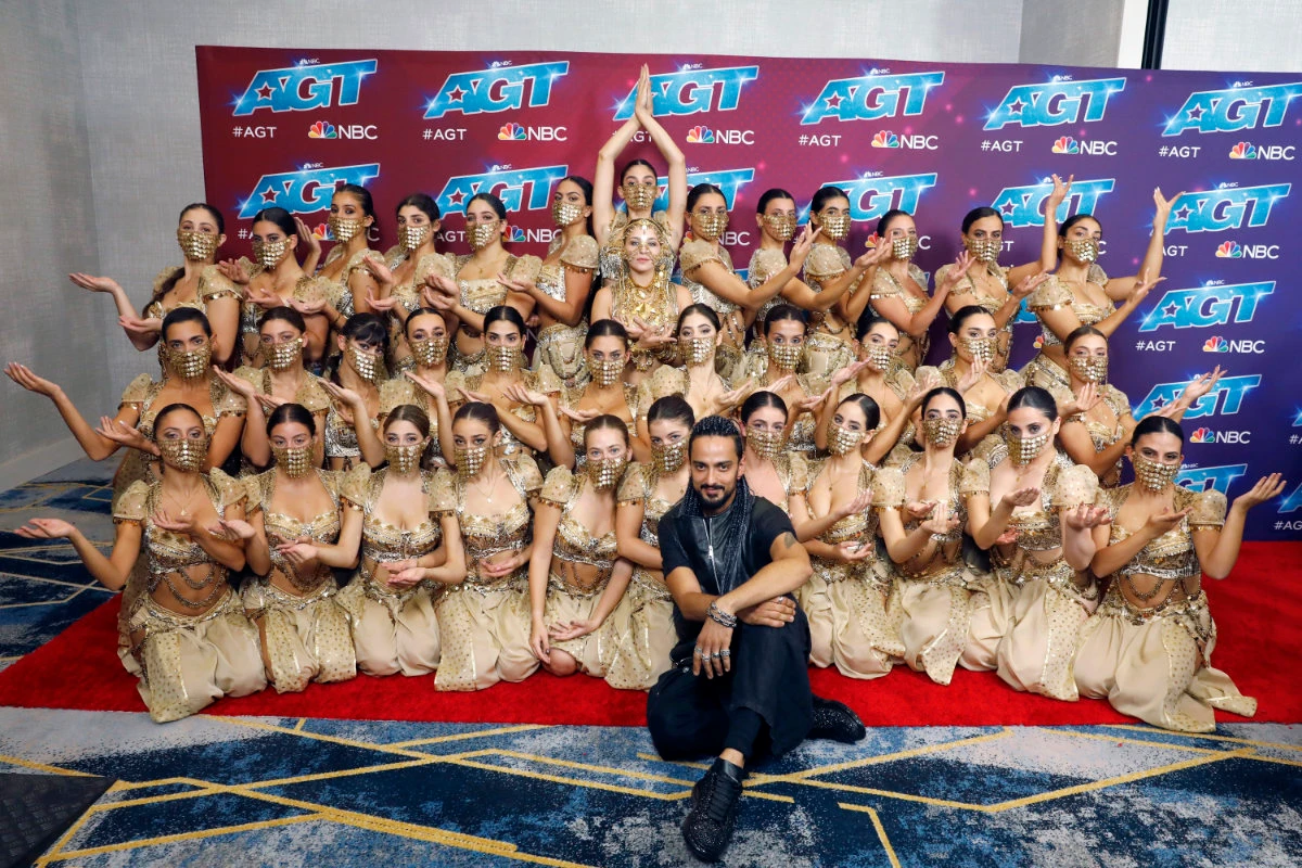 Terry Crews, center, poses with members of the female Lebanese dance troupe Mayyas after winning "America's Got Talent," on Sept. 14, 2022. (NBC via AP)