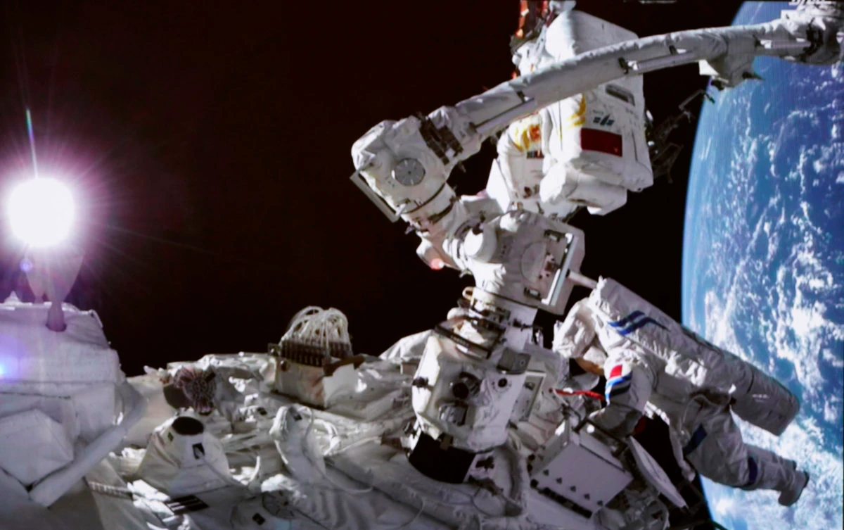 A screen at the Beijing Aerospace Control Center shows a Chinese astronaut conducting extravehicular activities around the space station lab module Wentian on Sept. 17, 2022. (Xinhua via AP)