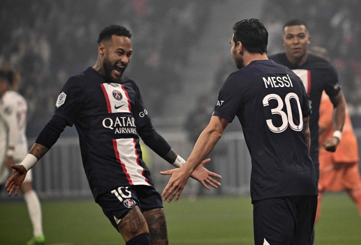 Paris Saint-Germain's Lionel Messi (R) celebrates with Neymar (L) after scoring a goal during the French L1 football match against Olympique Lyonnais at The Groupama Stadium in Decines-Charpieu, central-eastern France, on Sept. 18, 2022. (AFP)