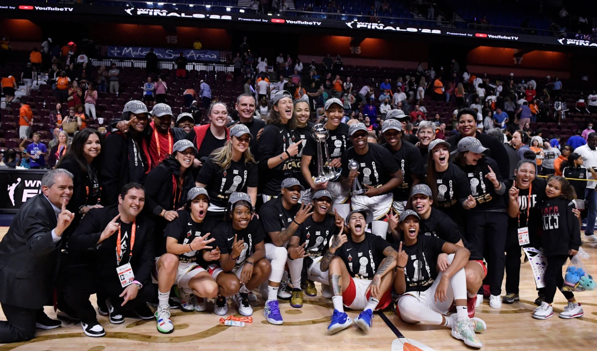 The Las Vegas Aces pose for a photo with the championship trophy after their win in the WNBA basketball finals against the Connecticut Sun Sunday in Uncasville, Conn. (AP)