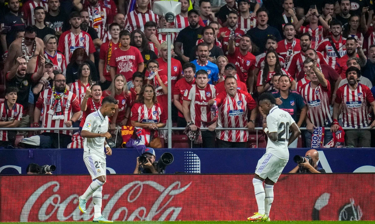 Real Madrid’s Rodrygo, left, celebrates after scoring with his teammate Vinicius Junior the opening goal during the Spanish La Liga match against Atletico Madrid at the Wanda Metropolitano stadium in Madrid, Sept. 18, 2022. (AP)