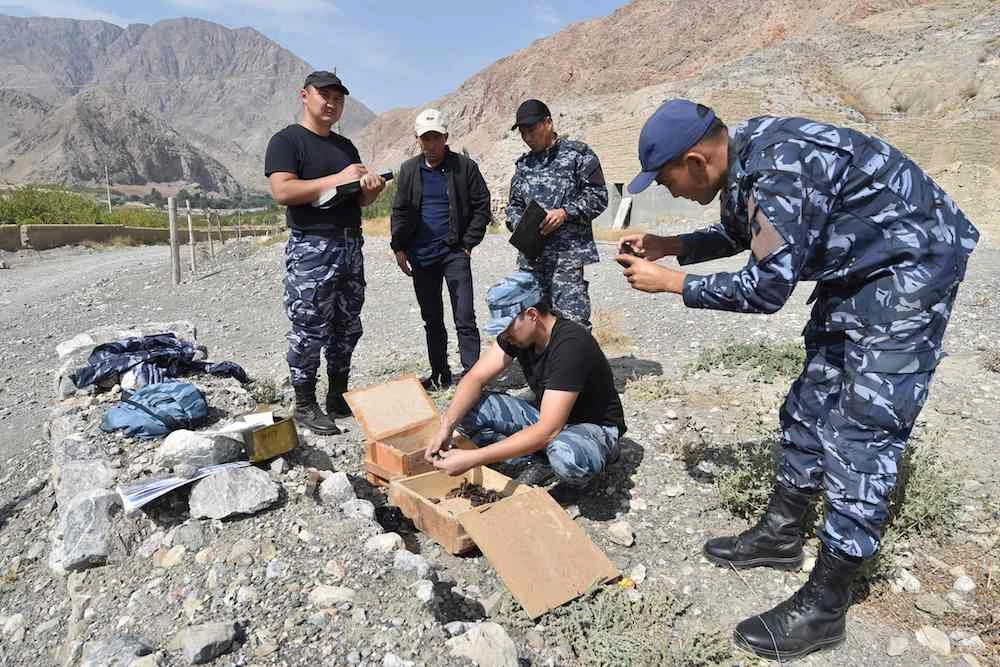 Police investigators work in the village of Kapchygay near the Kyrgyz-Tajik border, some 1000 kilometres from Bishkek, on September 21, 2022, as the worst violence the two ex-Soviet countries have seen in years broke out last week. (AFP)
