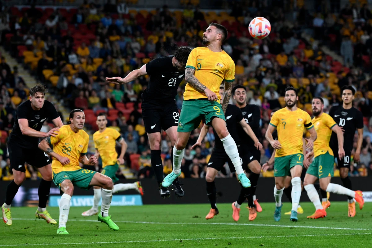 Australia's Jamie MaClaren, center right, and New Zealand's Tim Payne, center left, jump for a header during a friendly soccer international in Brisbane, on Sept. 22, 2022. (AP)