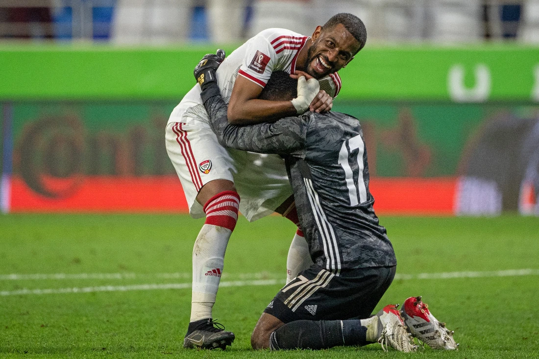 UAE's defender Abdulaziz Haikal hugs goalkeeper Khalid Eisa as they celebrate winning the 2022 Qatar World Cup Asian Qualifiers football match between UAE and South Korea. (File/AFP)