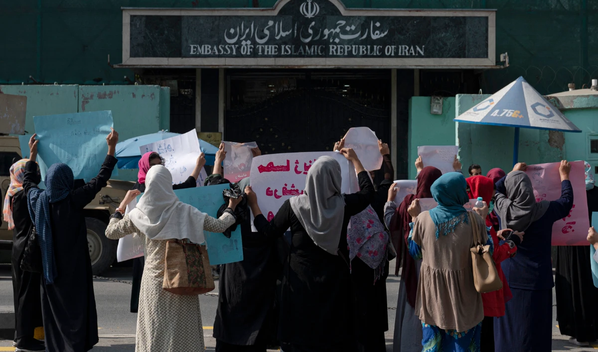 Afghan women hold placards as they take part in a rally in front of the Iranian embassy in Kabul on Thursday in support of protests that have erupted in Iran over the death of a woman in the custody of morality police. (AFP)