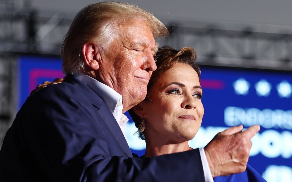 Donald Trump embraces Republican nominee for Governor of Arizona Kari Lake in Mesa, Arizona, Oct. 09, 2022. (AFP)