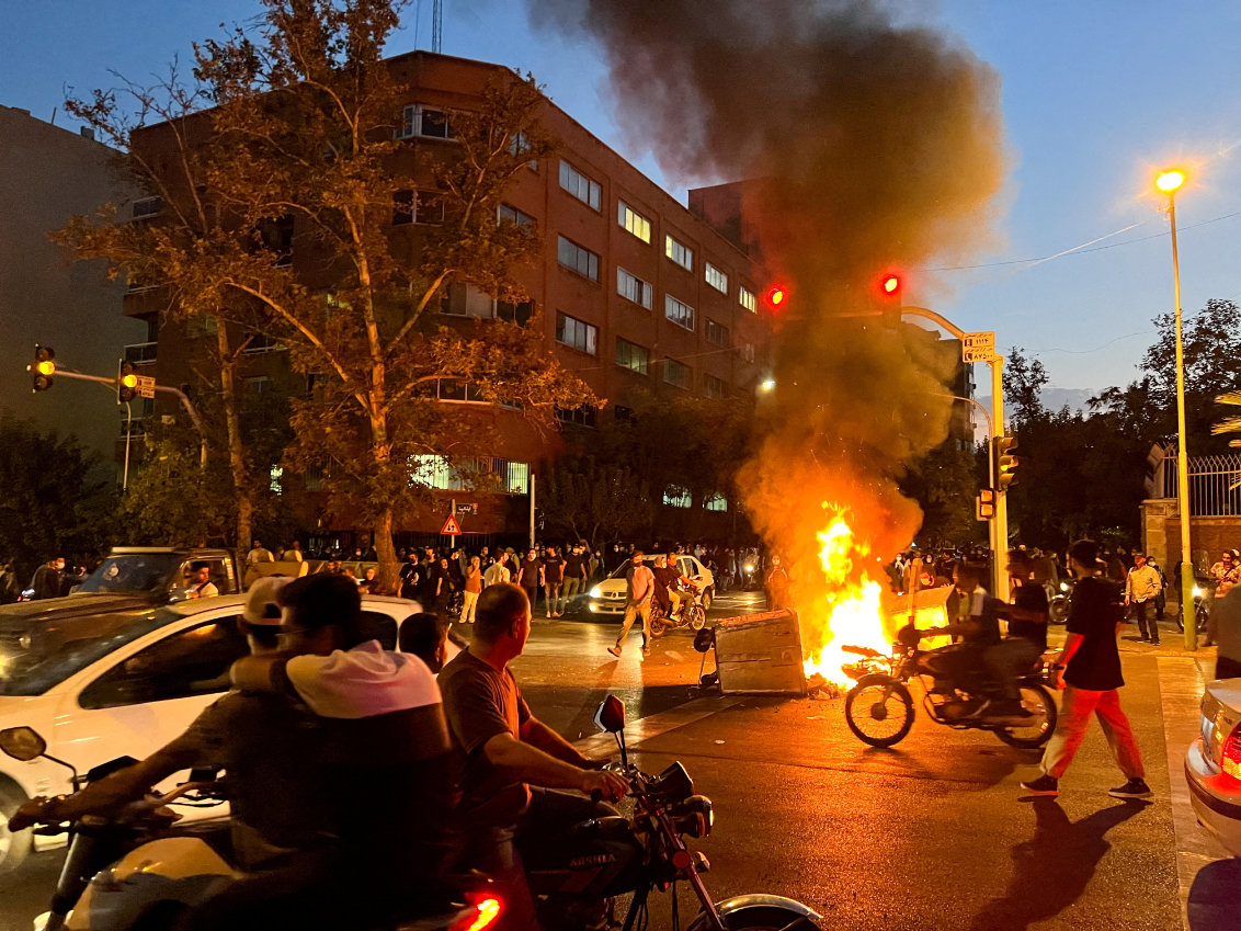 A police motorcycle burns during a protest over the death of Mahsa Amini in Tehran, Iran. (Reuters)