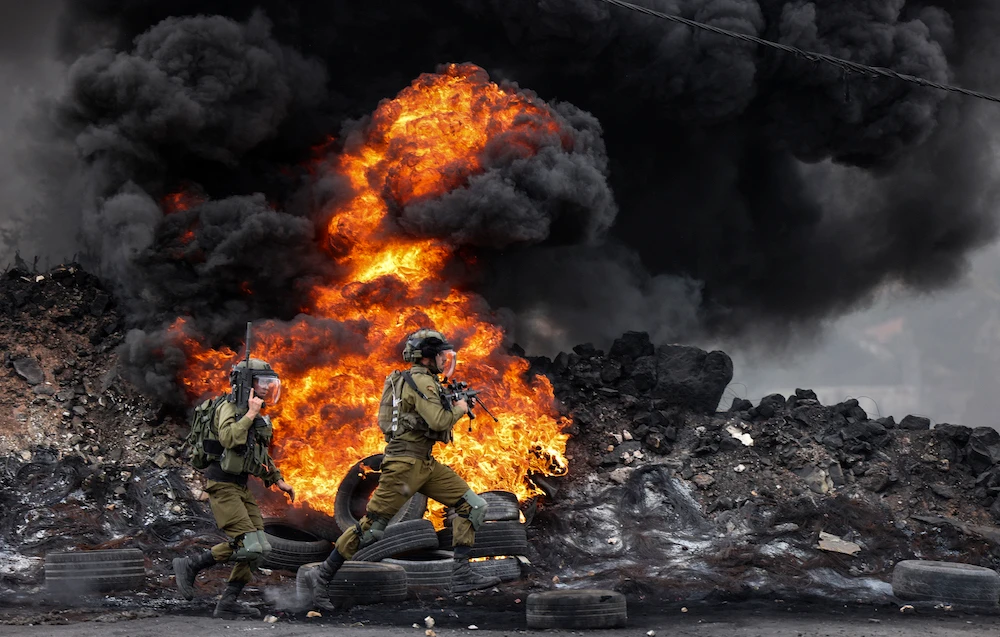 Israeli soldiers deploy amid clashes with Palestinian demonstrators following a protest against the expropriation of Palestinian land by Israel in the village of Kfar Qaddum in the occupied West Bank. (AFP)