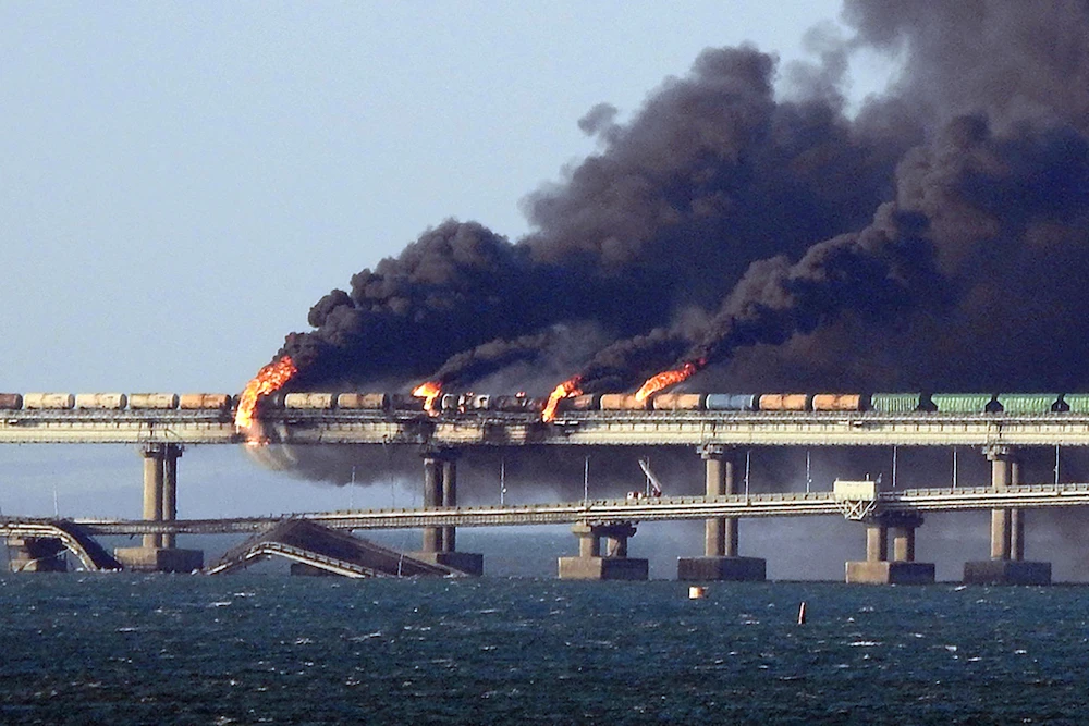 Black smoke billows from a fire on the Kerch bridge that links Crimea to Russia, after a truck exploded, near Kerch, on October 8, 2022. (AFP)