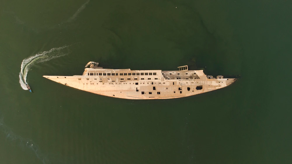 An aerial picture shows the capsized hull of "Al Mansur", the private yacht of toppled Iraqi President Saddam Hussein, in the Shatt Al-Arab waterway. (AFP)