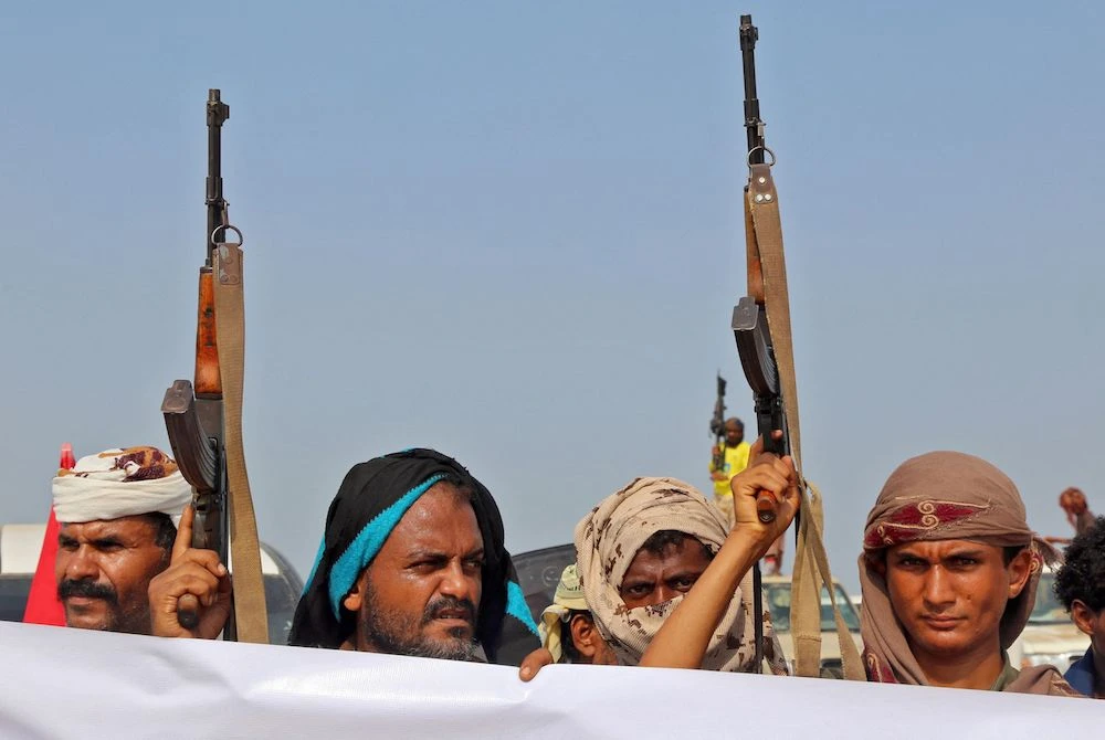 Armed militants gather for a protest against Yemen's Houthi militia in the Khokha region of the country's war-ravaged western province of Hodeidah. (AFP)