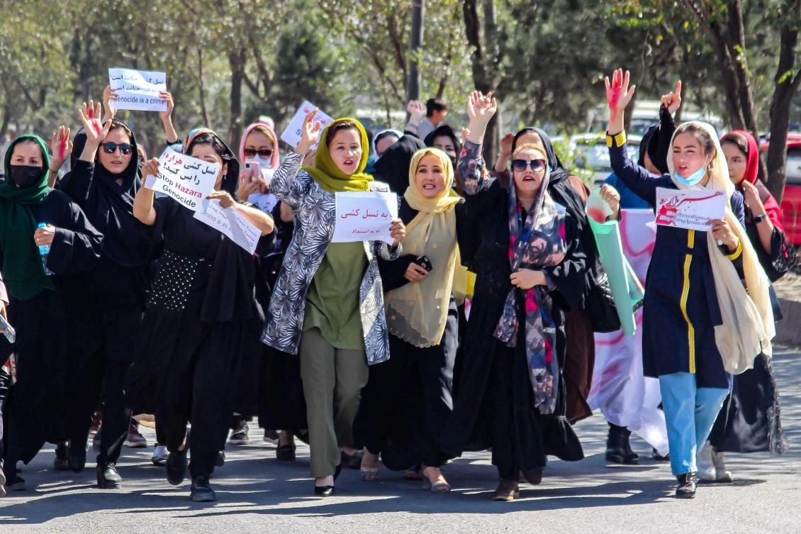 Afghan women display placards and chant slogans during a protest they call ‘Stop Hazara genocide’ a day after a suicide bomb attack at Dasht-e-Barchi learning center, in Kabul on Saturday. (AFP)