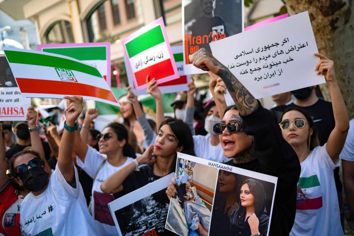 Protestors shout slogans as they hold banners with the portrait of Iranian Mahsa Amini while they take part in a rally outside the Iranian consulate in Istanbul on September 29, 2022. (AFP)