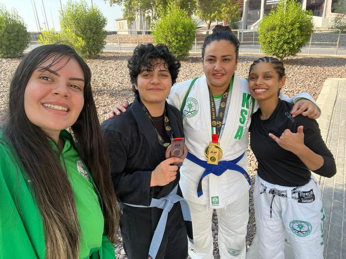 Dina Elias (second from right) and Haya Al-Sheikh celebrate their respective gold and bronze medals with Saudi national team colleagues. (Twitter/@Saudi_JJF)