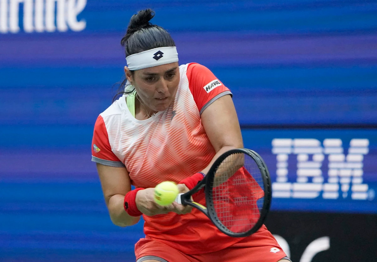 Tunisia's Ons Jabeur hits a return to Poland's Iga Swiatek during their 2022 US Open Tennis tournament women's singles final match in New York. (AFP)