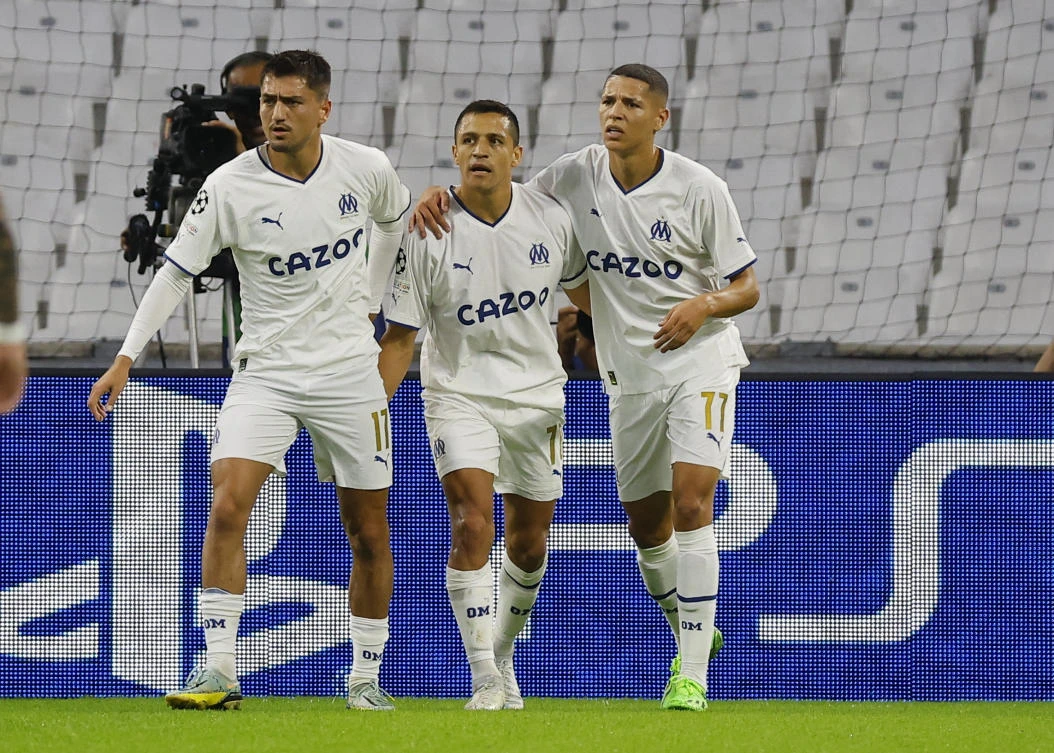 Olympique de Marseille’s Alexis Sanchez celebrates scoring their first goal with Amine Harit and Cengiz Under during their Champions League against Sporting CP at Orange Velodrome, Marseille on Tuesday. (Reuters)