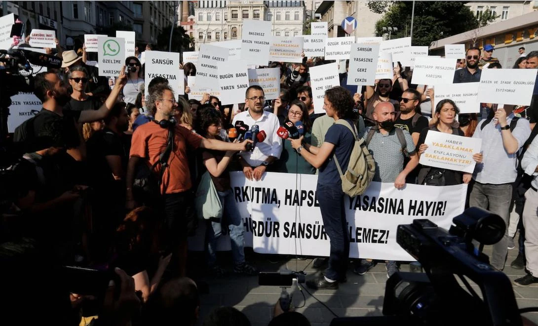 Representatives of various Turkish journalists’ associations, wearing black face masks, gathered outside parliament in Ankara and in Istanbul to protest the bill. (Reuters)