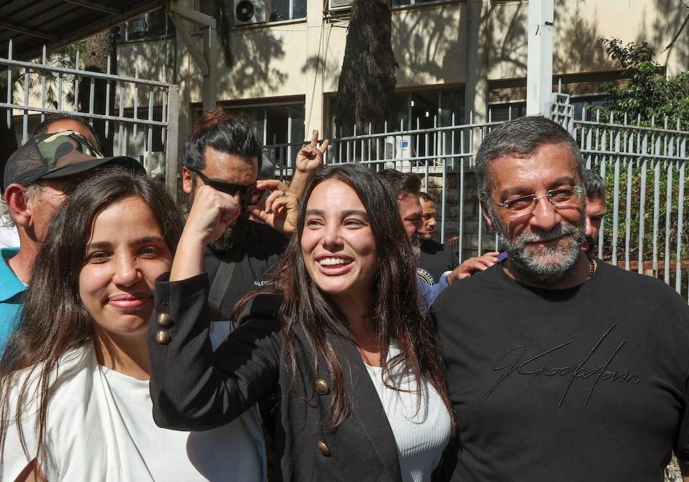 Sali Hafiz, center, turned herself in Wednesday night, and was free on a bail of 1 million pounds. (Reuters)