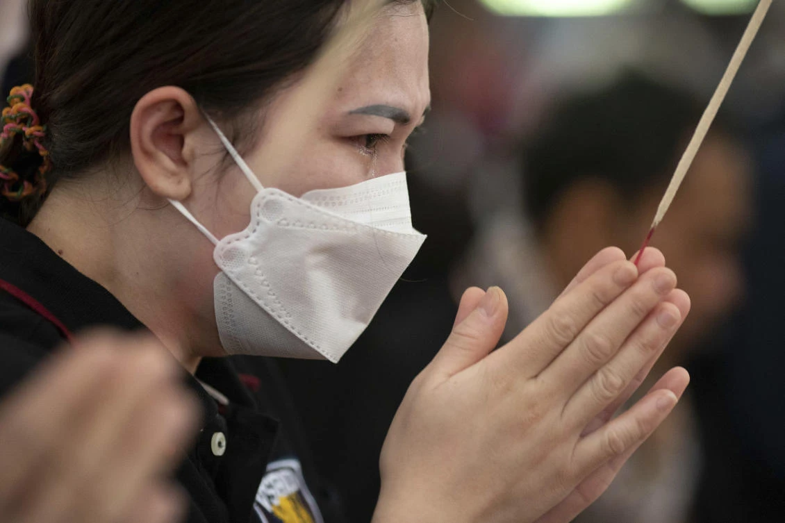 Relatives of the victims of a mass killing attack pray during a Buddhist ceremony at Wat Rat Samakee temple in the rural town of Uthai Sawan, north eastern Thailand, Saturday, Oct. 8, 2022. (AP)