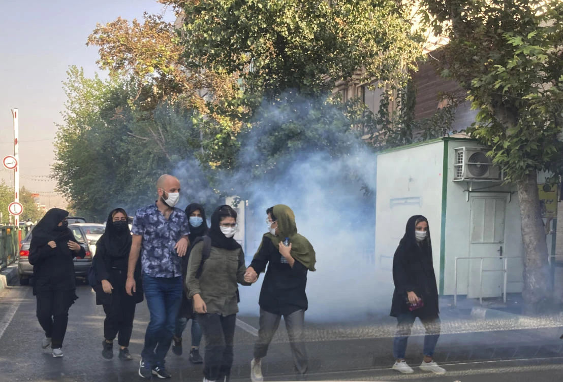 Tear gas is fired by security to disperse protestors in front of the Tehran University, Iran. (File/AP)