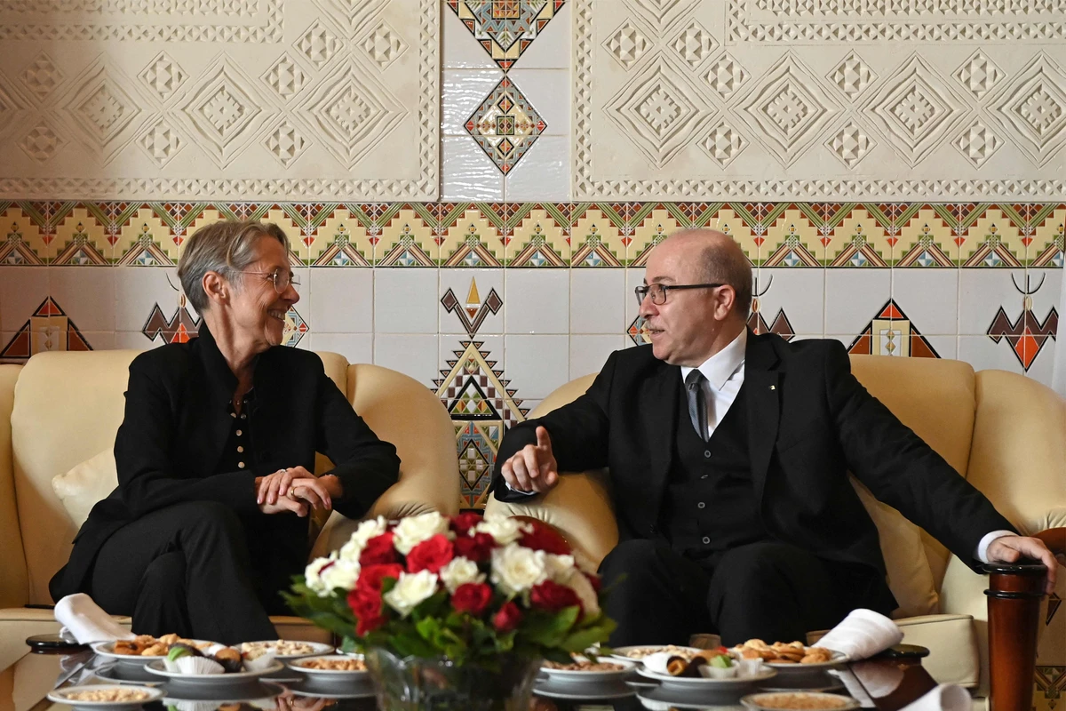 Algeria's Prime Minister Aymen Benabderrahmane (R) meets with French Prime Minister Elisabeth Borne upon her arrival in the capital Algiers on October 9, 2022. (AFP)