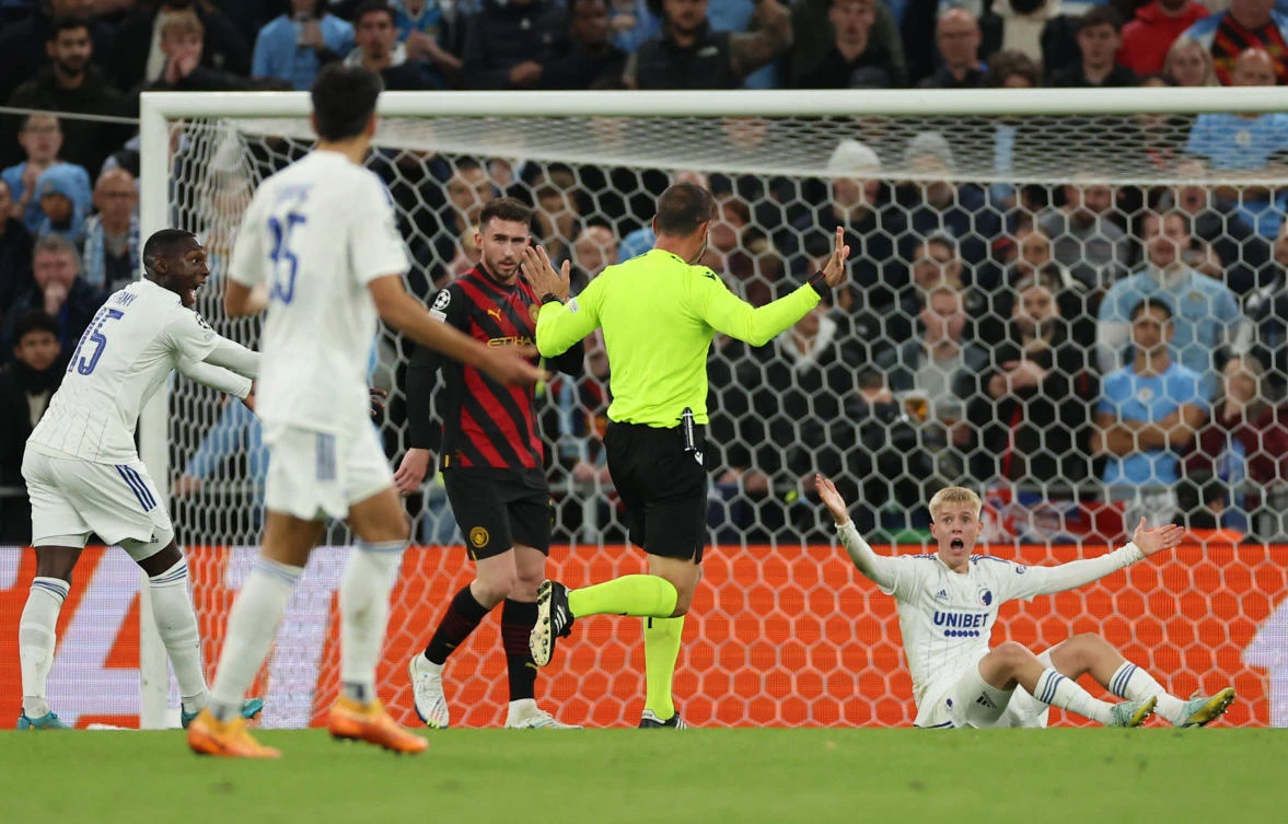 Referee Artur Soares Dias waves no foul after Manchester City’s Sergio Gomez fouls FC Copenhagen’s Hakon Arnar Haraldsson before showing him a red card during their Champions League match at Parken, Copenhagen on Tuesday. (Reuters)