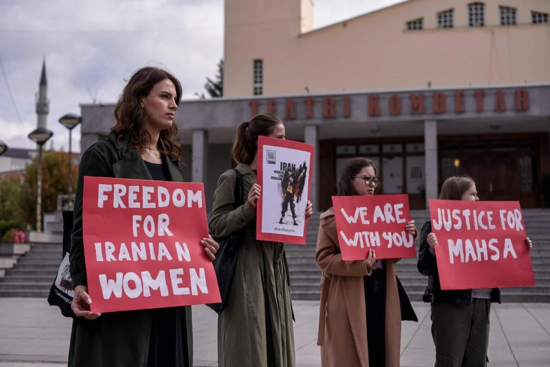Women take part in a rally in support of Iranian women in Pristina on Wednesday. A wave of unrest has rocked Iran since 22-year-old Masha Amini died on September 16 after her arrest by the morality police in Tehran. (AFP)