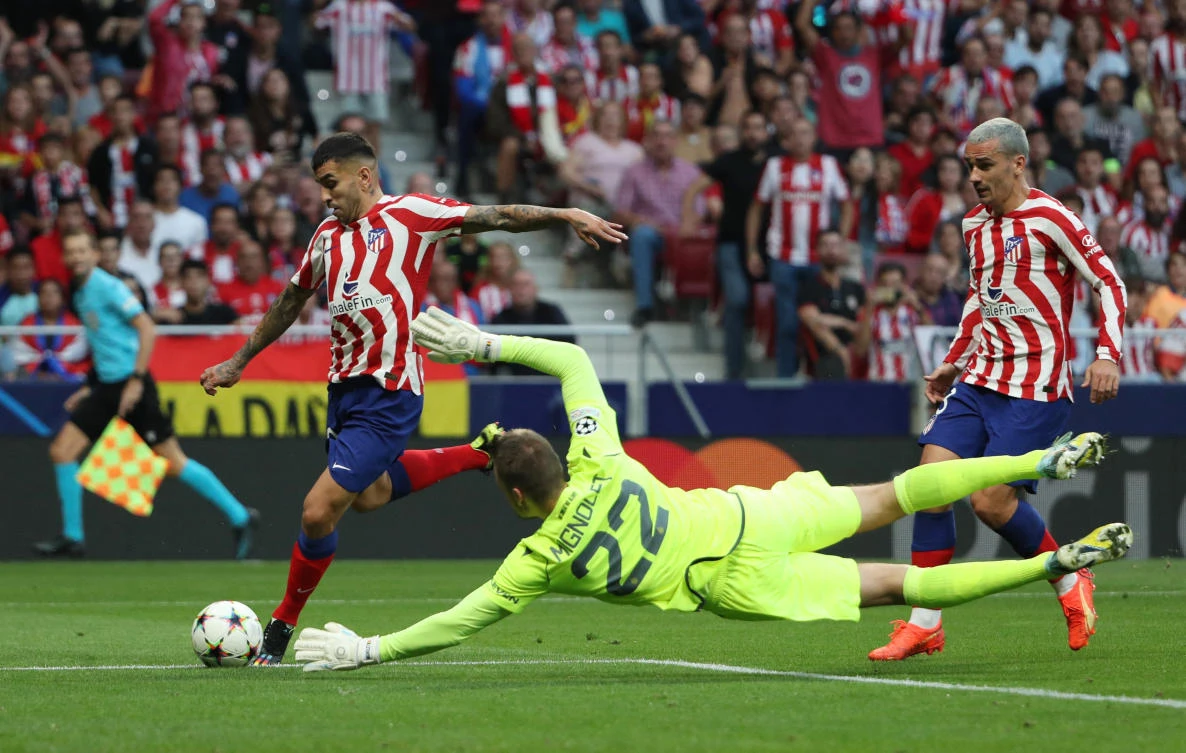 Atletico Madrid’s Angel Correa in action with Club Brugge’s Simon Mignolet during their Champions League match at the Metropolitano, Madrid on Wednesday. (Reuters)