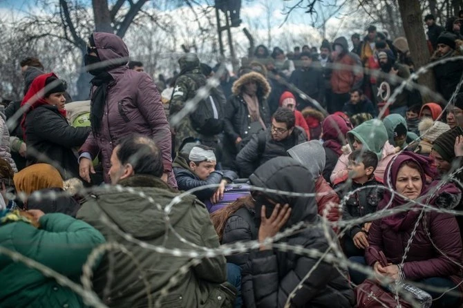 Migrants at border crossing between Turkey and Greece. Latvian authorities have “brutally treated” refugees and migrants trying to cross the Belarus border, reported Amnesty International. (AFP/File)