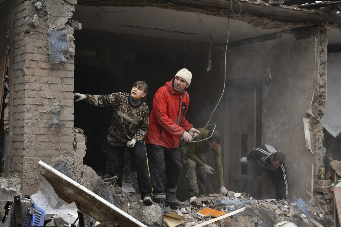 People work to remove debris from a damaged house after an overnight Russian shelling, in Sloviansk, Donetsk region, on Monday. (AP)