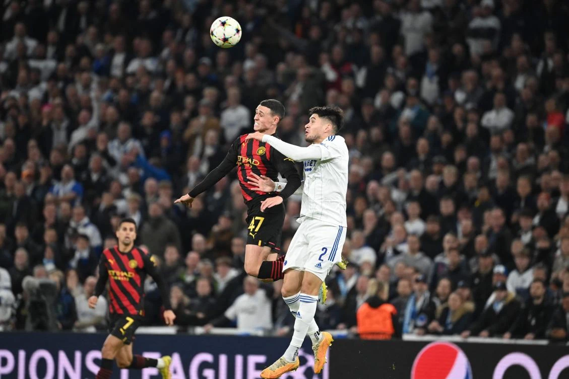 Manchester City’s English midfielder Phil Foden and FC Copenhagen’s defender Kevin Diks vie for a header during their UEFA Champions League match in Copenhagen on October 11, 2022. (AFP)