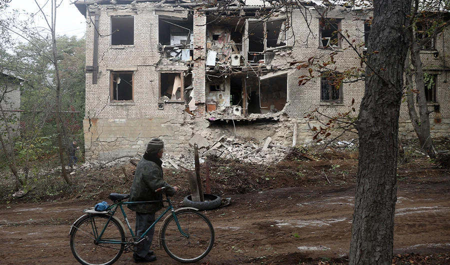 A local resident looks at a residential building destroyed by a missile strike in Konstantinovka in the eastern Donetsk region on October 14, 2022. (AFP)