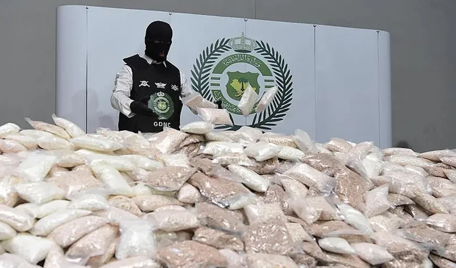 A man stands near confiscated drugs in Saudi Arabia on August 31, 2022. (SPA/FILE)