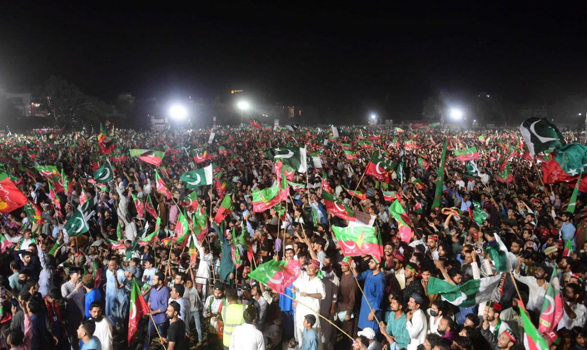 Supporters of Pakistan’s former Prime Minister Imran Khan listen to his speech during a by-election campaign meeting in Karachi on Oct. 14, 2022. (AFP)